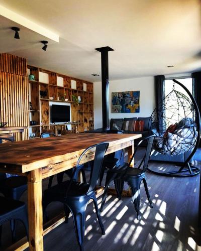 a dining room with a wooden table and chairs at CASA INTIYACO in Atos Pampa