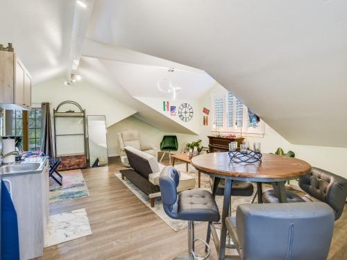 a kitchen and living room with a table and chairs at Cozy Oasis in SE Austin in Buda