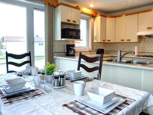 a kitchen with a table with chairs and a dining room at Logis des prodiges in Rouyn