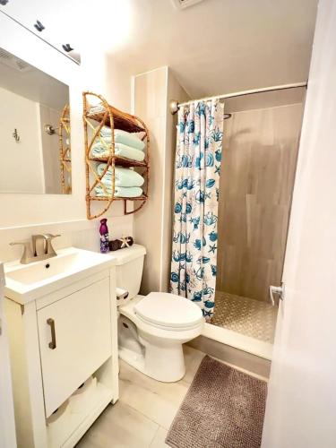 a bathroom with a toilet and a sink and a shower at OCEAN FRONT Condo Daytona Beach! in Daytona Beach