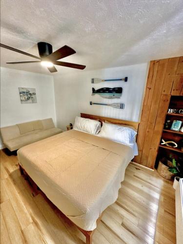 a bedroom with a bed and a ceiling fan at OCEAN FRONT Condo Daytona Beach! in Daytona Beach
