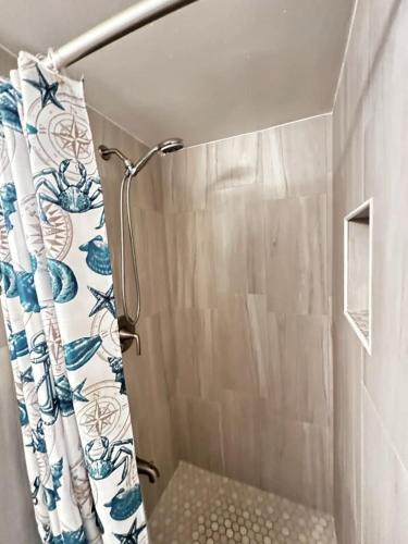 a shower with a shower curtain in a bathroom at OCEAN FRONT Condo Daytona Beach! in Daytona Beach