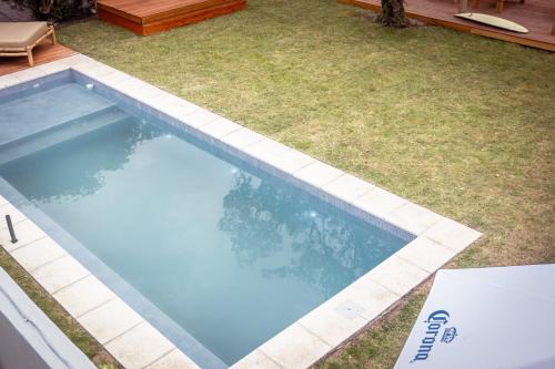 a swimming pool in a yard with grass at Las Golondrinas Mar del Plata in Mar del Plata