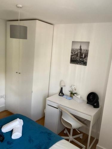 a bedroom with a desk and a bed and a bed and a desk at Lovely Private Rooms in Euston, Central London in London