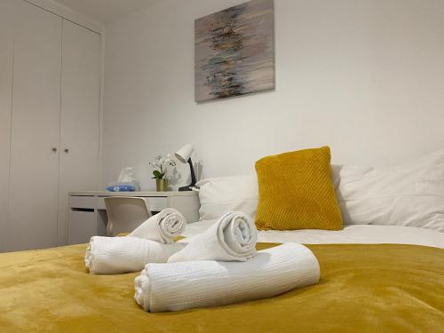 a room with a bed with towels on it at Lovely Private Rooms in Euston, Central London in London