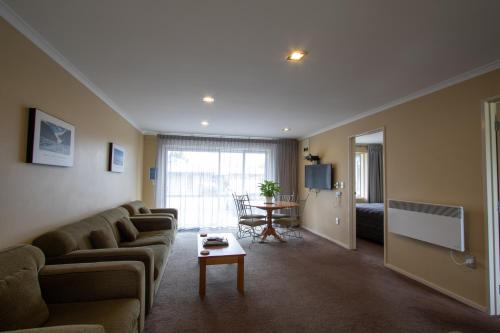 a living room with a couch and a table at Annabelle Motel in Hokitika