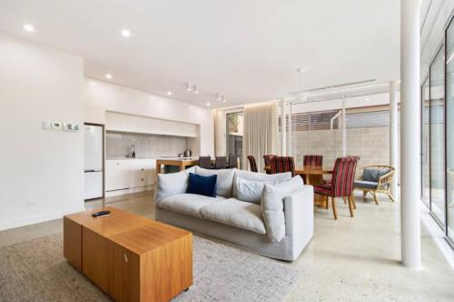 a living room with a couch and a table at Apartment G4 in Adelaide