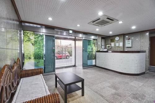 a lobby with a bar with a table and chairs at New World Hotel Yongsan in Seoul