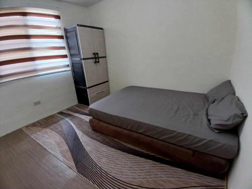 Katil atau katil-katil dalam bilik di Transient Home Abucay Bataan - 2 BR