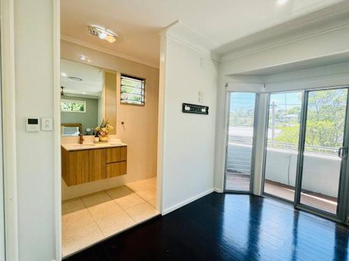 an empty room with a hallway with a sink and a bathroom at Luxury beachside sanctuary in Adamstown