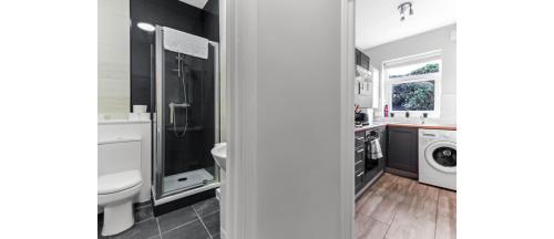 a bathroom with a sink and a washing machine at Terrific 1 BD Flat in London in London