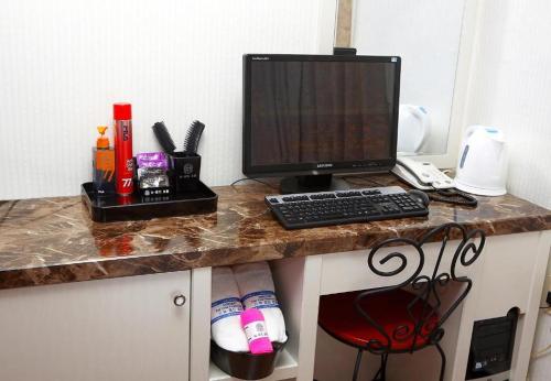 a desk with a computer on top of it at New World Hotel Yongsan in Seoul