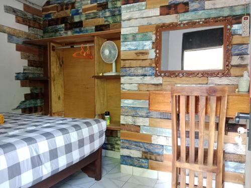 a bedroom with a wall made out of reclaimed wood at Wikan House in Bebandem