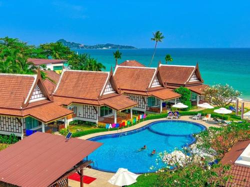 an aerial view of a resort with a swimming pool at Aura Samui Best Beach Hotel - SHA Plus in Lamai
