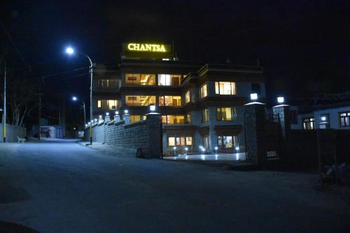 a building with a sign on it at night at HOTEL CHANTSA in Leh