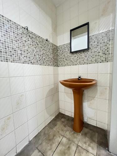 a bathroom with a wooden sink and a mirror at Malakoff Residence in Recife