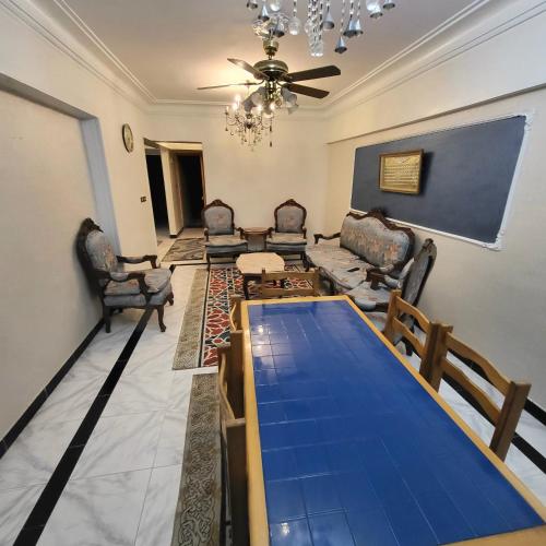a living room with a table and chairs at شقه فى ميامى بالاسكندريه مطله على البحر in Alexandria