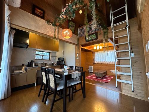 a kitchen and dining room with a table and chairs at 舞鶴ふるるファームコテージ in Maizuru