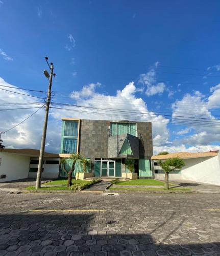 a building with a pole in front of it at El palacio de cristal in Sangolquí