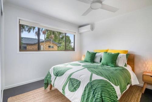 a bedroom with a bed and a window at Lennox Heaven in Lennox Head