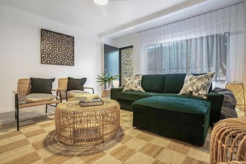 a living room with a green couch and chairs at Lennox Heaven in Lennox Head