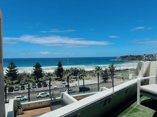 a view of the beach from the balcony of a building at Bondi Beach Waves 2 Beachfront Apartment in Sydney