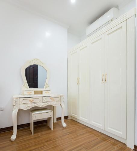a white dressing table with a mirror on top at The Peninsula Haiphong in Hai Phong