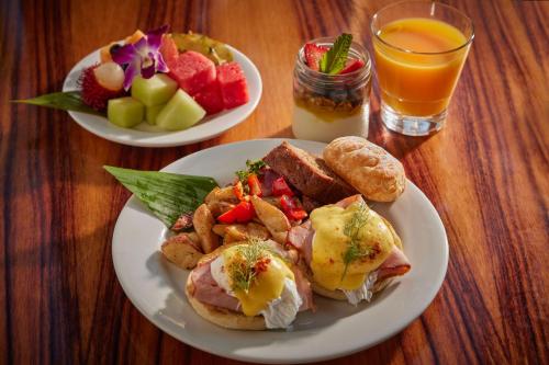 a table with two plates of food and a drink at Hilton Waikoloa Village in Waikoloa