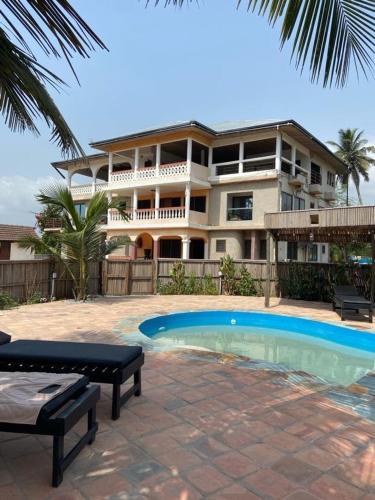 a large apartment building with a pool in front of it at Afiki in Ankwanda