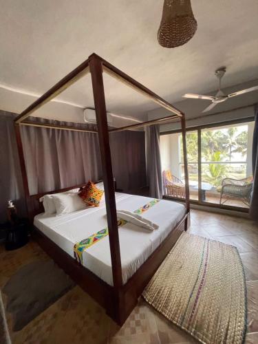 a bedroom with a canopy bed in a room at Afiki in Ankwanda