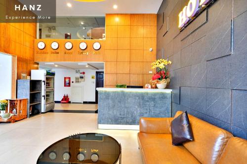 a lobby of a store with a couch and a counter at HANZ King Airport Hotel in Ho Chi Minh City