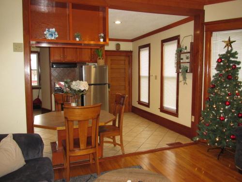 a living room with a christmas tree and a table at Victorian Home Near Downtown in Minneapolis
