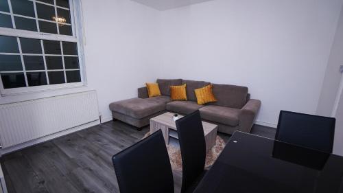 a living room with a couch and a table at Sky Rooms Modern Luxury 2 Bed Apartment in Birmingham