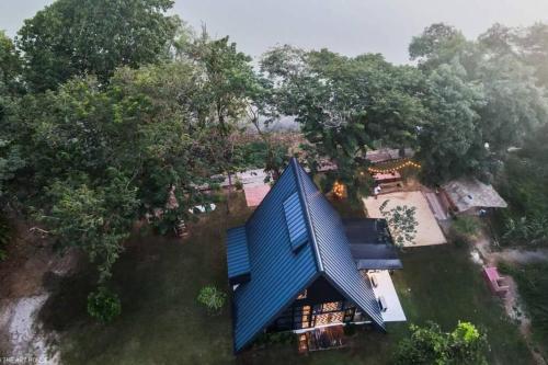 an overhead view of a house with a blue roof at Kaitoon's River House in Ratchaburi