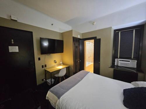 a bedroom with a bed and a desk in it at Hotel-Style @ The Mansfield Midtown in New York