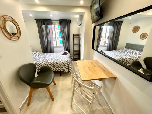 Camera di piccole dimensioni con specchio, tavolo e sedia di Apartamentos con baño privado frente al metro L5 Barcelona-Hospitalet a Hospitalet de Llobregat