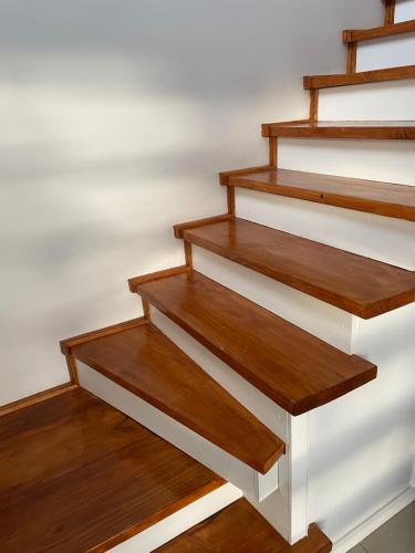 a set of wooden stairs in a room at Departamento manantiales 1 in Punta Arenas