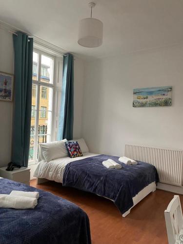 a bedroom with two beds and a window at Private Bedrooms in Camden Town, Central London (10) in London