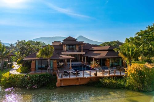 a house on a bridge over a body of water at Luxury 5 Bedroom Villa Close to Beach SRS in Hua Hin