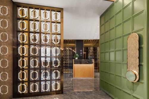 a store with green walls and a skateboard on the wall at Sheraton Chengdu Lido Hotel in Chengdu