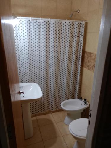 a bathroom with a sink and a toilet and a shower at Los nidos 3 in Villa Cura Brochero