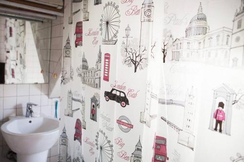 a bathroom with a shower curtain with drawings on it at Good In Beach_ Lovely Place in Pyoseon (Haevichi) in Seogwipo