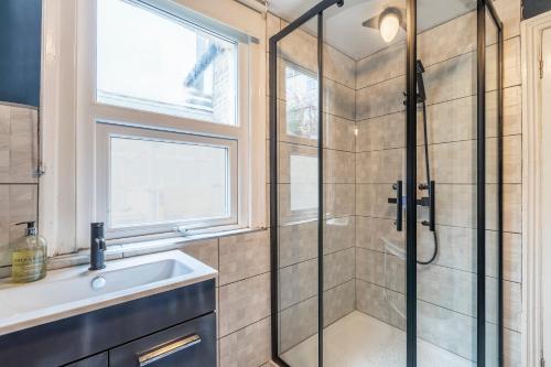 a bathroom with a shower and a sink at Folkestone Ramblers Rest in Kent