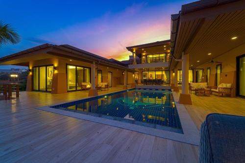 a house with a swimming pool in front of a house at Luxury 5 Bedroom Villa Close to Beach SRS in Hua Hin