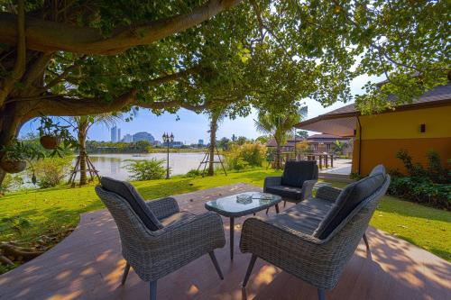 a patio with chairs and a table with a view of a river at Luxury 5 Bedroom Villa Close to Beach SRS in Hua Hin