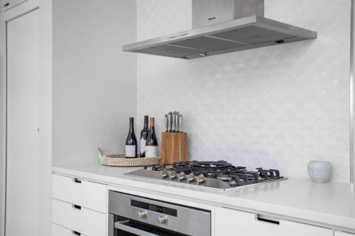 a kitchen with a stove top oven in a kitchen at Prime Position in Gerroa