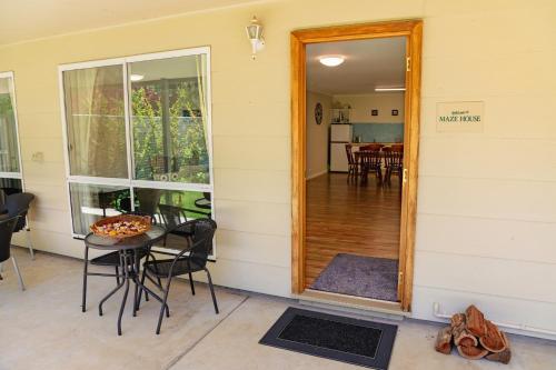 a door to a patio with a table and chairs at Brookfield Guest House in Myrrhee