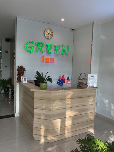 a green sign on the wall of a store at Green Inn Phu Quoc Hotel in Phu Quoc