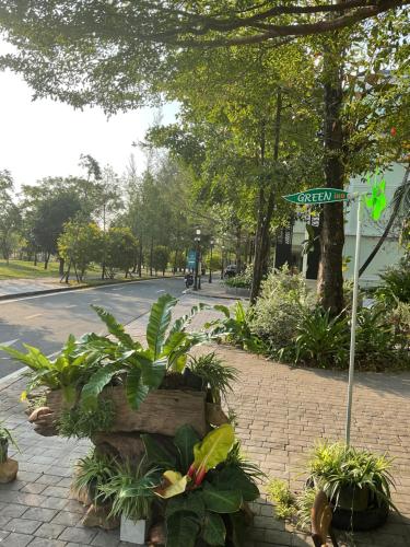 a street sign and some plants on a sidewalk at Green Inn Phu Quoc Hotel in Phu Quoc