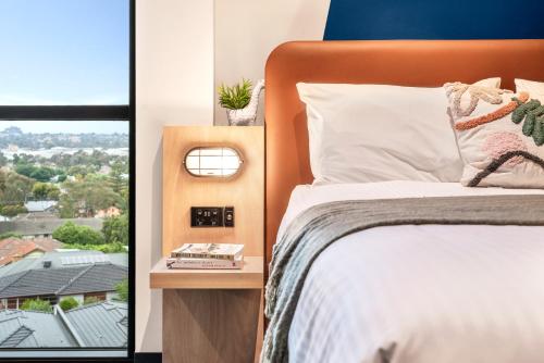 a bedroom with a bed and a window at Together Co-Living Melbourne in Melbourne